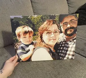 A completed custom paint by numbers canvas of a family portrait held by a happy customer