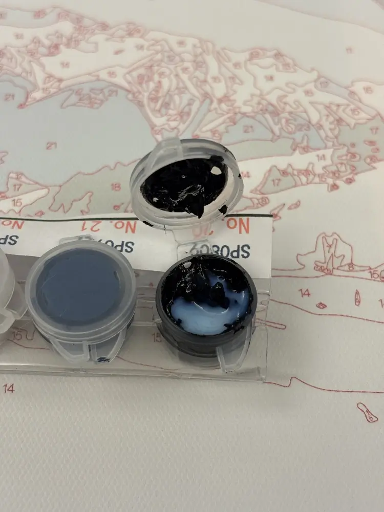 Adding a drop of white flow medium into a dark acrylic paint pot for the PBN flow method.